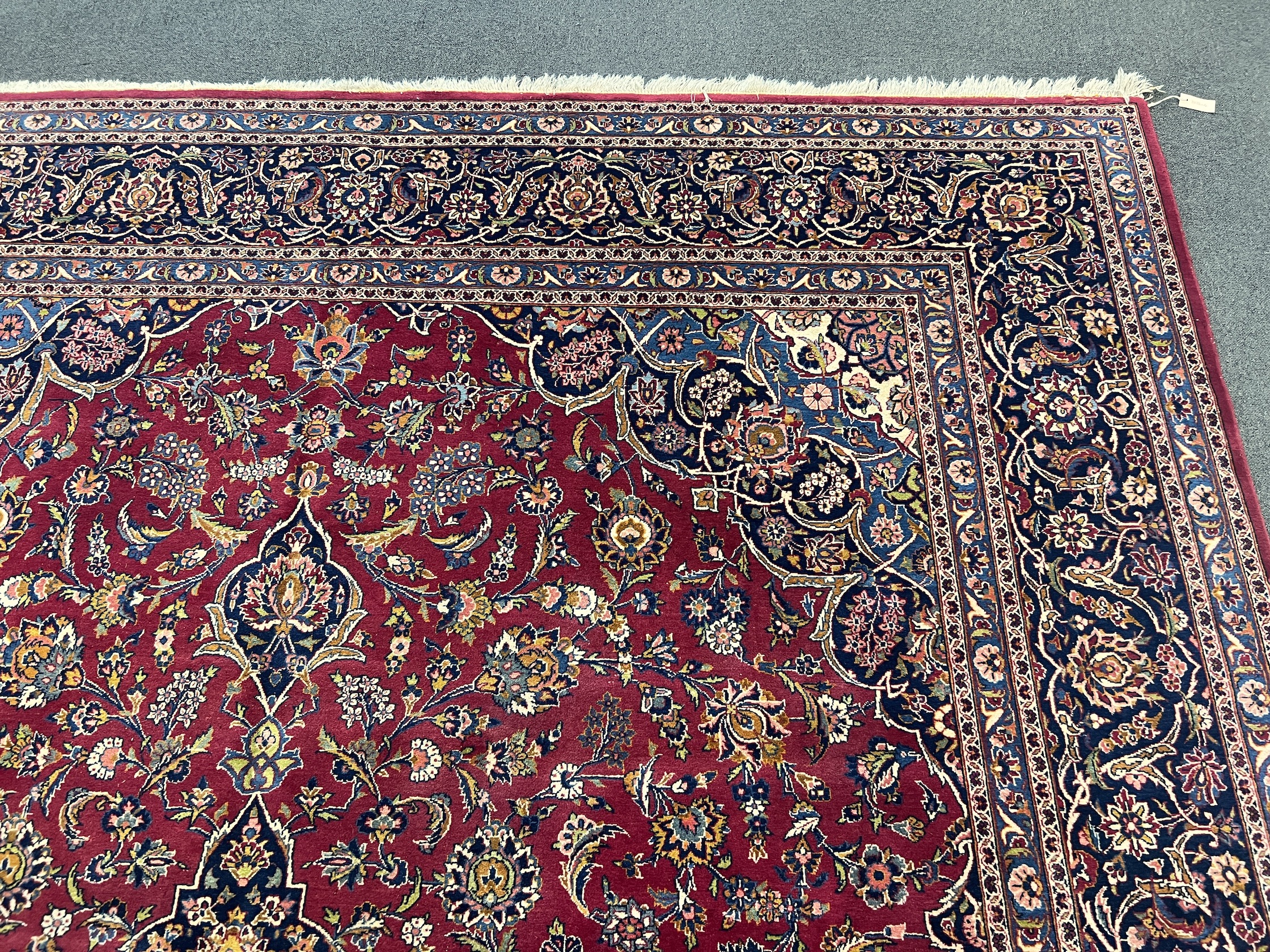 A Kashan burgundy ground carpet